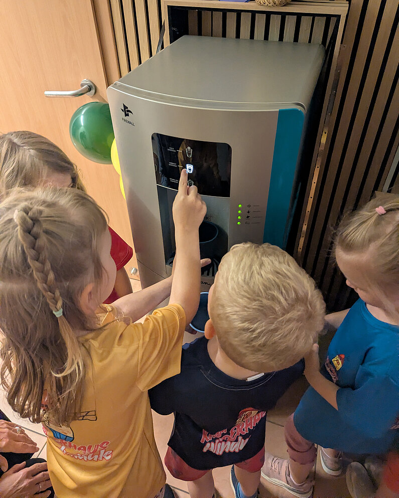 Mehrere Kinder am Wasserspender.